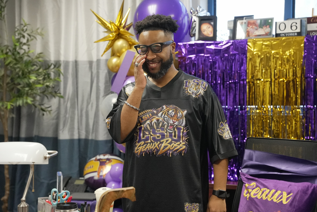 Principal wiping a tear away in his office