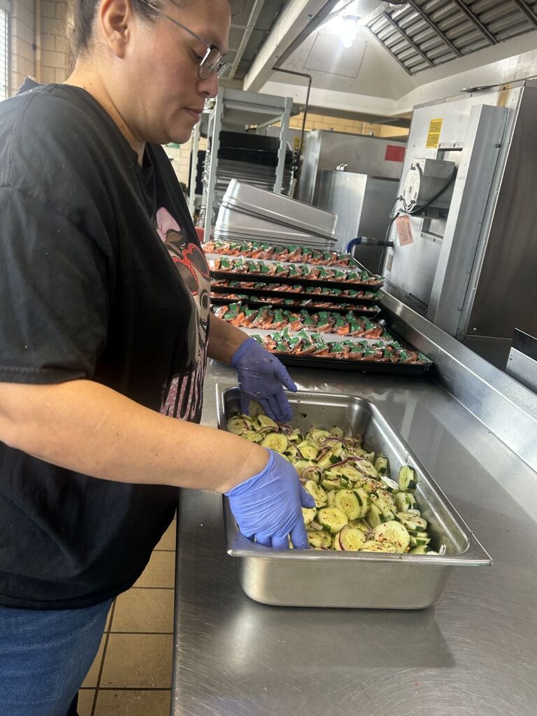 cafeteria working preparing cucumber salad