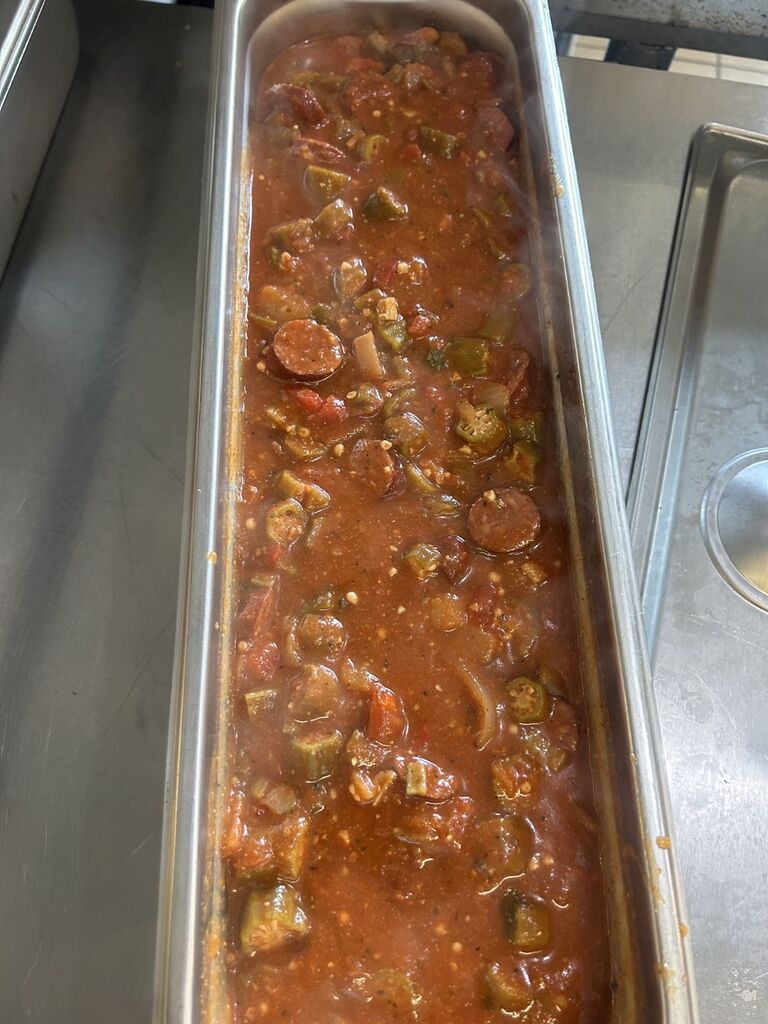 cafeteria pan filled with okra and sausage