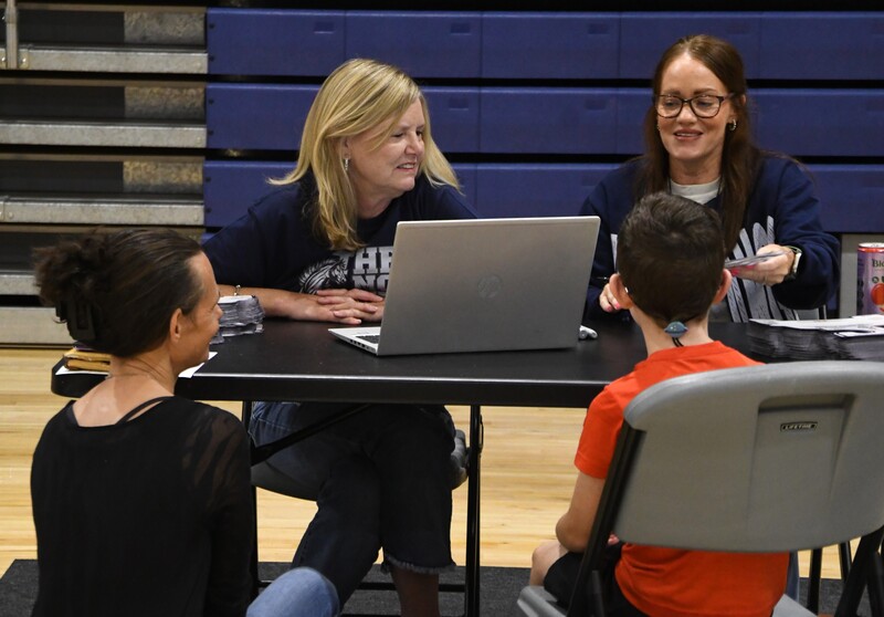 Staff members helping family register