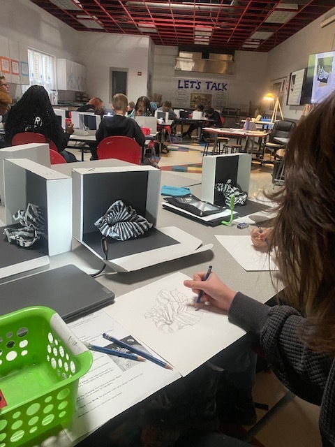 Art students creating illusion by applying the 5 elements of shading