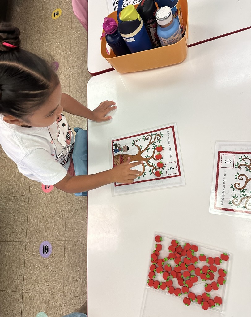 Student counting apples on a worksheet