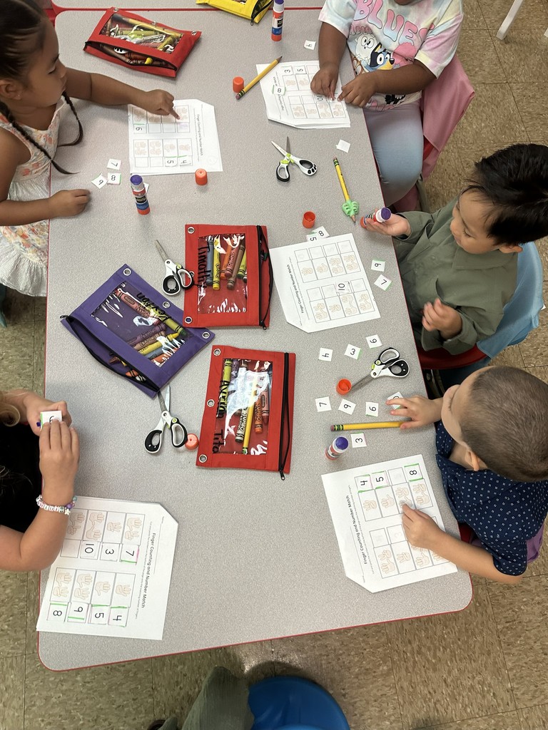 Students working on cutting pasting and coloring