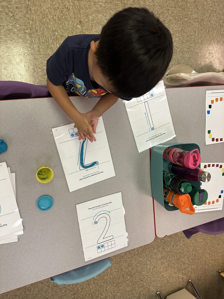 Student molding play-doh into the number 7