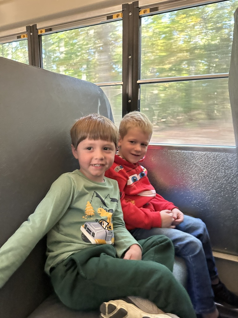 2 students on the bus to the pumpkin patch