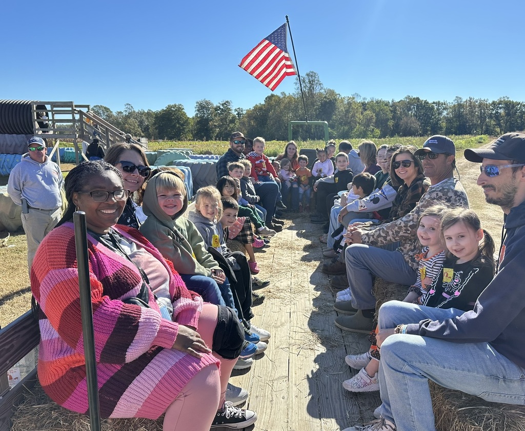 Students with parents and staff on tractor ride to pumpkin patch