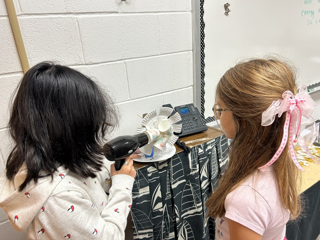 Two students working on their windmill