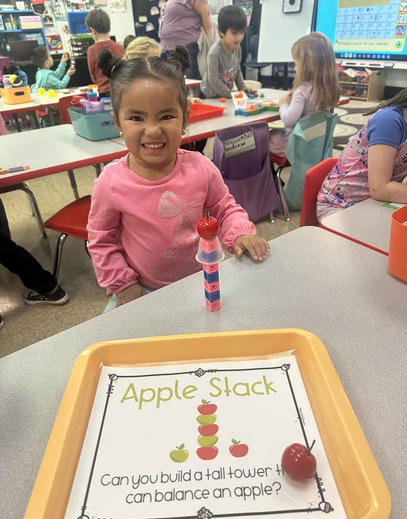 Student building an apple stack