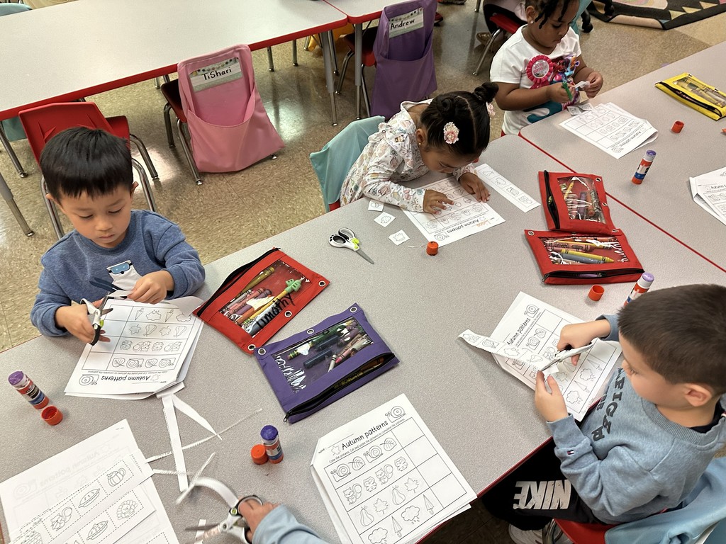 Students working on cutting pasting and coloring