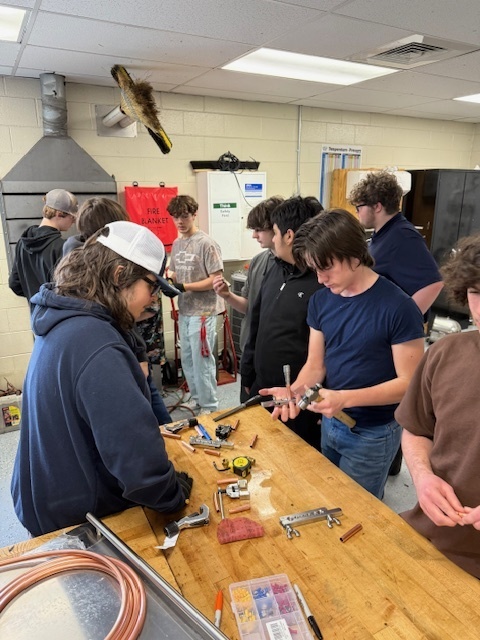 Students looking at tools