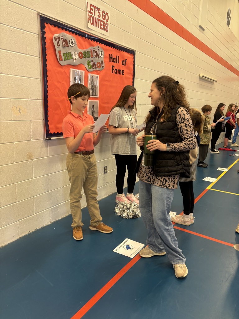 Student participating at WPPS  Wax Museum with a teacher