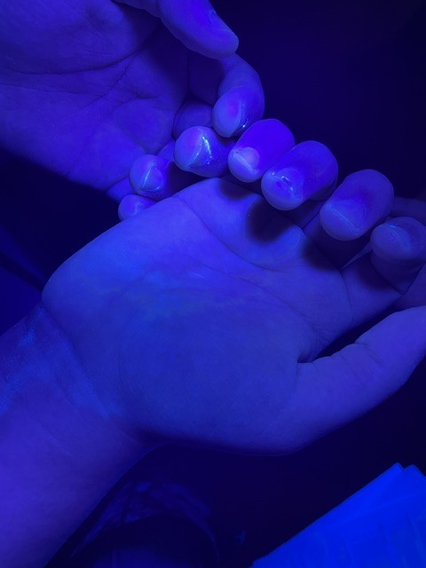 black light showing hand washing technique