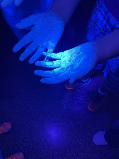 Handwashing showing bacteria under black light