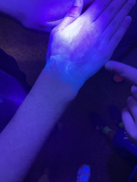 black light showing hand washing technique