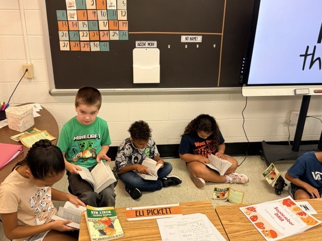 Students with dictionaries of West Point Rotary