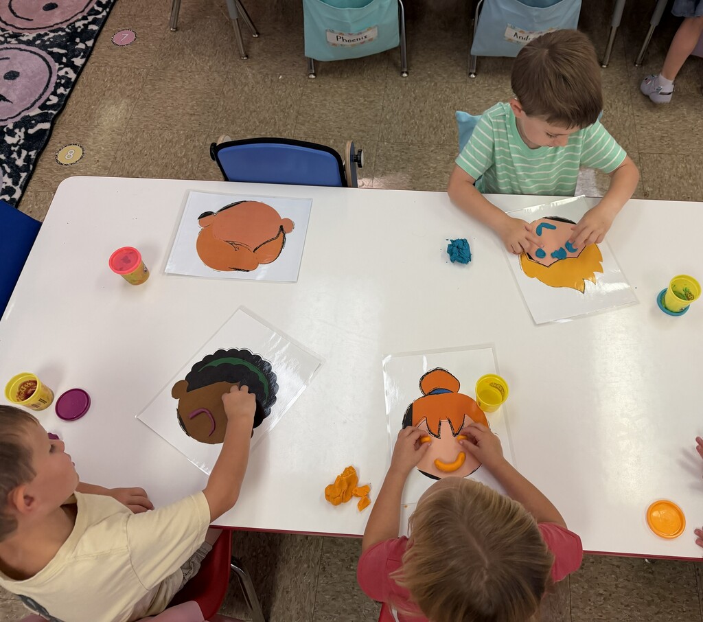 Students using playdough to make faces