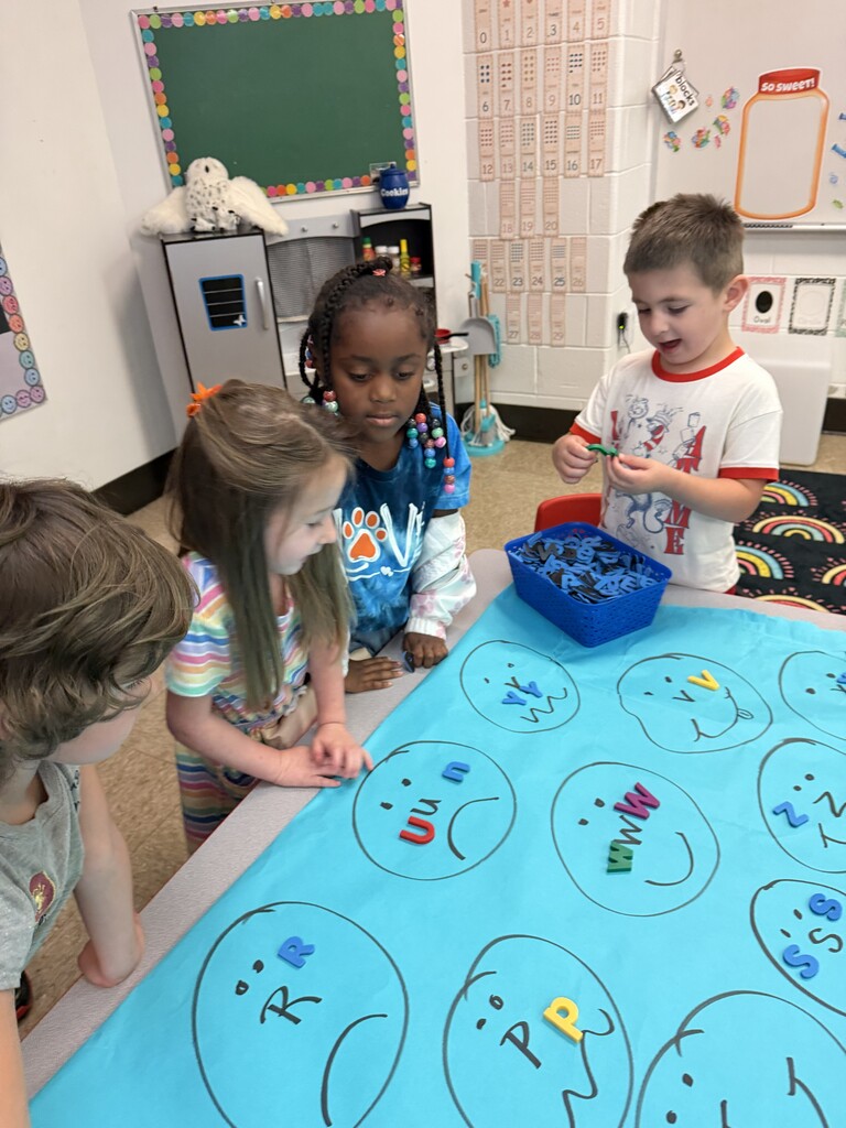 Students drawing faces with letters