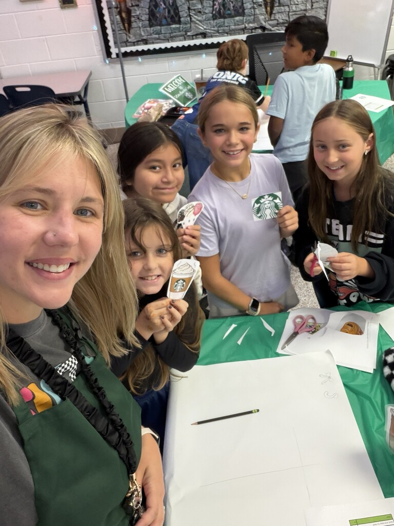 Fifth-grade students participate in Starbucks-themed learning activities, including a book tasting, stem-and-leaf data challenge, coffee bean estimation, and place value games, while enjoying themed snacks and drinks.
