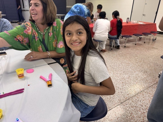 ELL students and their families enjoy a welcome-back cookout while students participate in five hands-on science activities hosted by the ELL Family Engagement Committee.