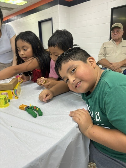 ELL students and their families enjoy a welcome-back cookout while students participate in five hands-on science activities hosted by the ELL Family Engagement Committee.
