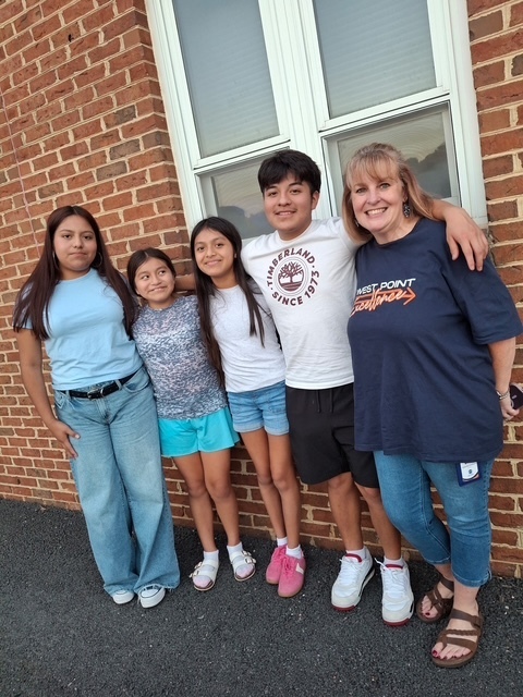 ELL students and their families enjoy a welcome-back cookout while students participate in five hands-on science activities hosted by the ELL Family Engagement Committee.