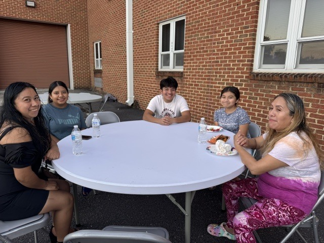 ELL students and their families enjoy a welcome-back cookout while students participate in five hands-on science activities hosted by the ELL Family Engagement Committee.