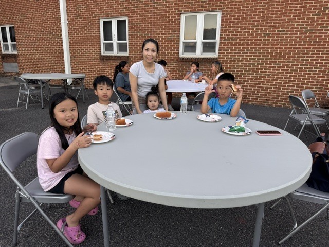 ELL students and their families enjoy a welcome-back cookout while students participate in five hands-on science activities hosted by the ELL Family Engagement Committee.