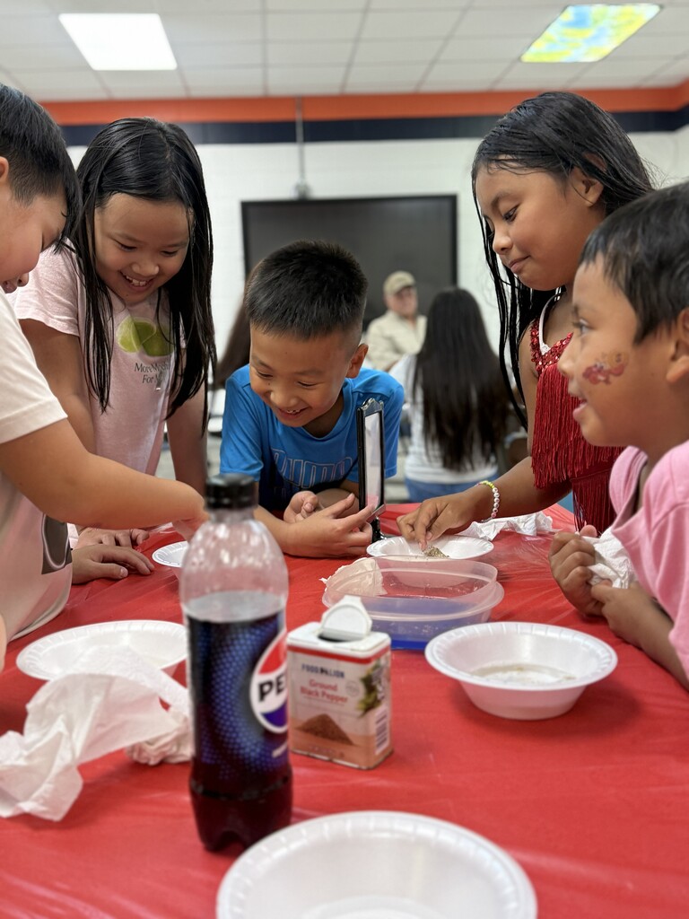 ELL students and their families enjoy a welcome-back cookout while students participate in five hands-on science activities hosted by the ELL Family Engagement Committee.