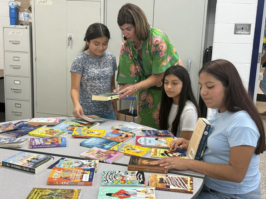 ELL students and their families enjoy a welcome-back cookout while students participate in five hands-on science activities hosted by the ELL Family Engagement Committee.