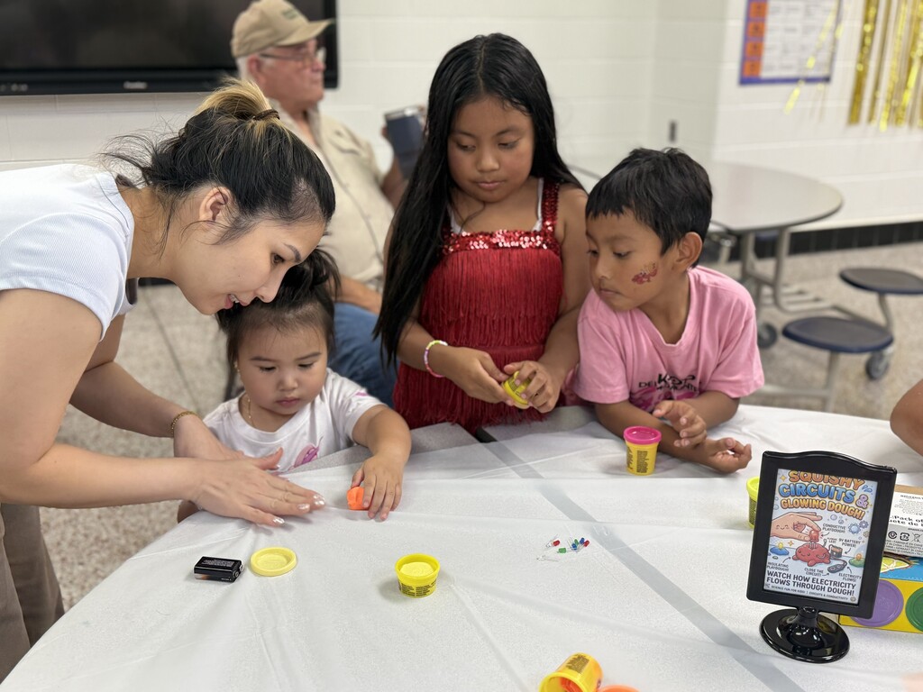 ELL students and their families enjoy a welcome-back cookout while students participate in five hands-on science activities hosted by the ELL Family Engagement Committee.