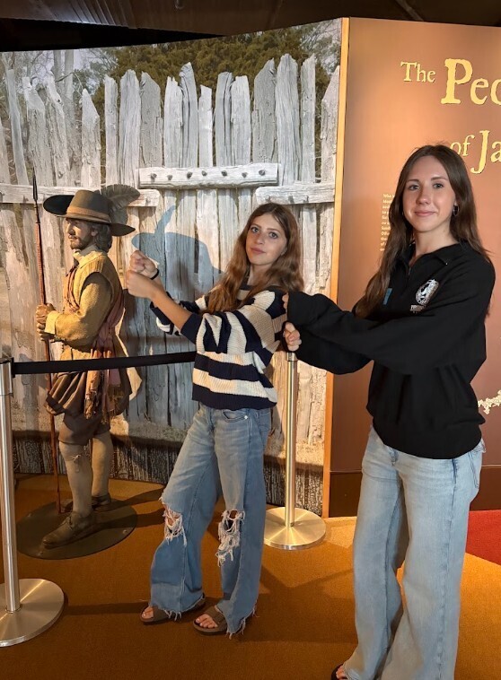 2 students standing next to an exhibit of The People of Jamestown at  the Historic Jamestown Rediscovery Center