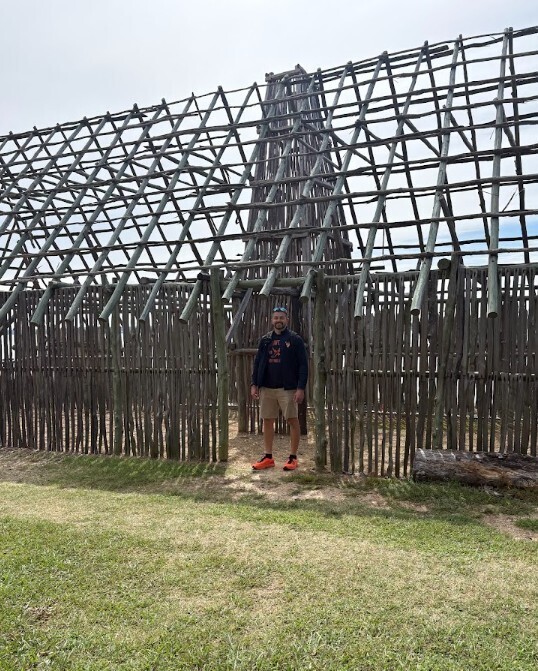 Mr. McCallister standing in the doorway of one of the wooden forts