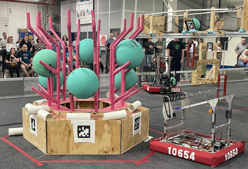 Robot heading towards a rack of green balls