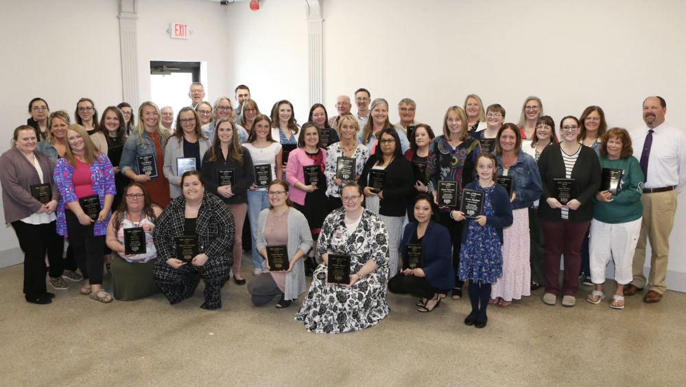 A bunch of people holding their award