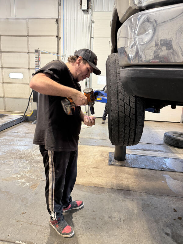 Student working on a tire