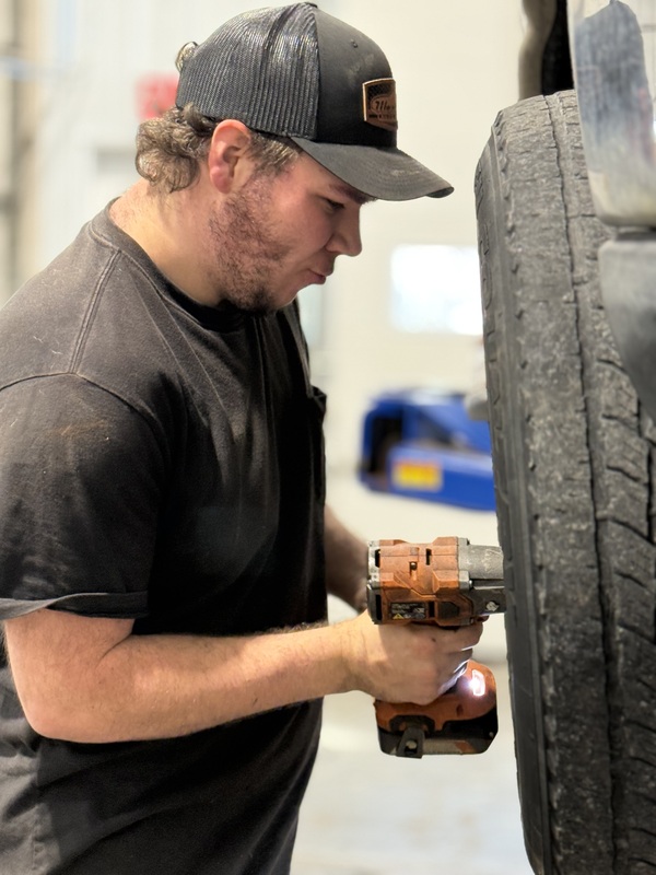 Student working on a tire