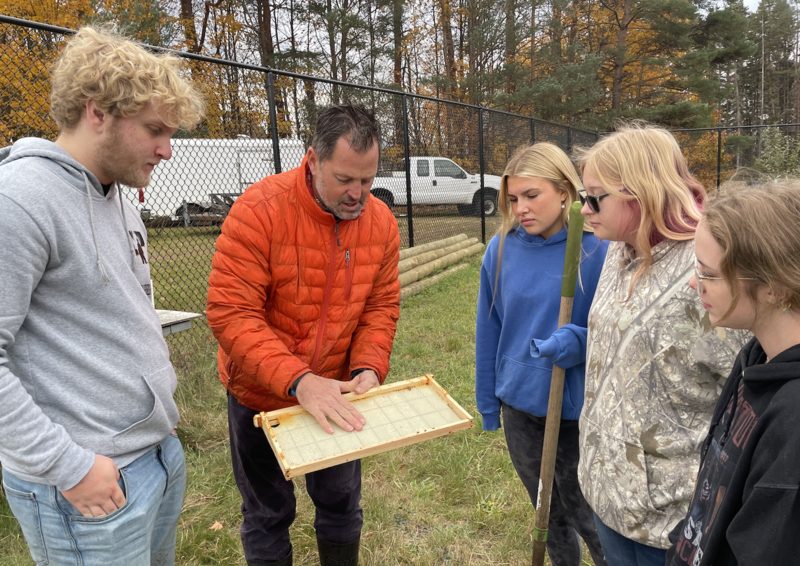 Teacher talking to students outside