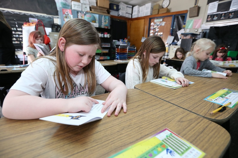 Students reading books at a table