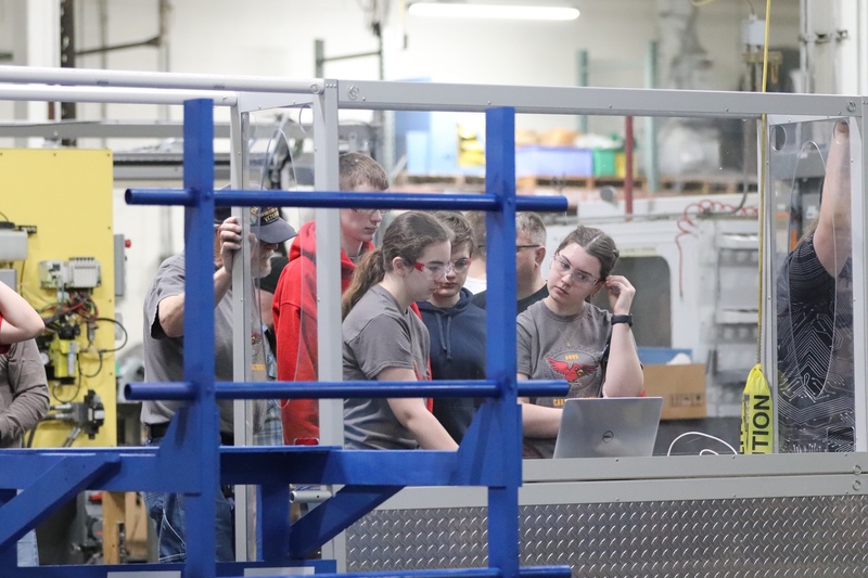 Group of students looking at a laptop