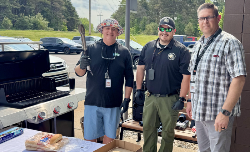 Adam with Andy Higley and Chad Skiba at a bbq grill