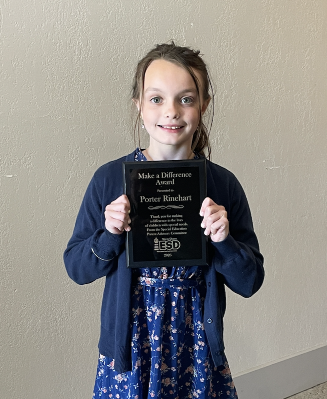Student holding an award