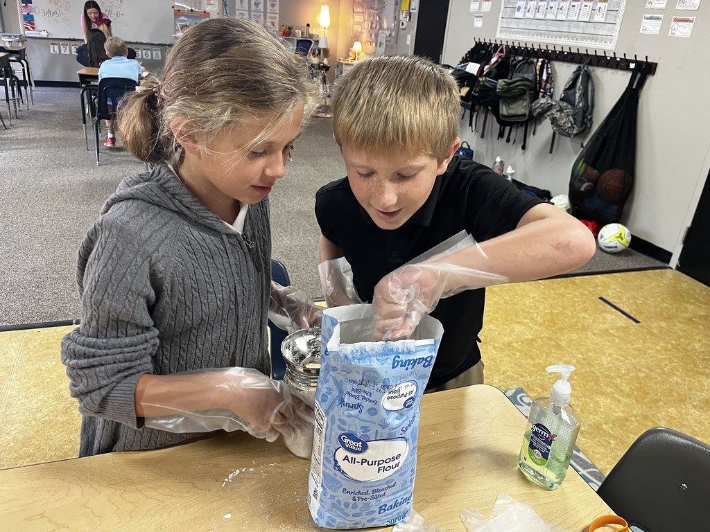 4th graders measuring ingredients for their cookie mix