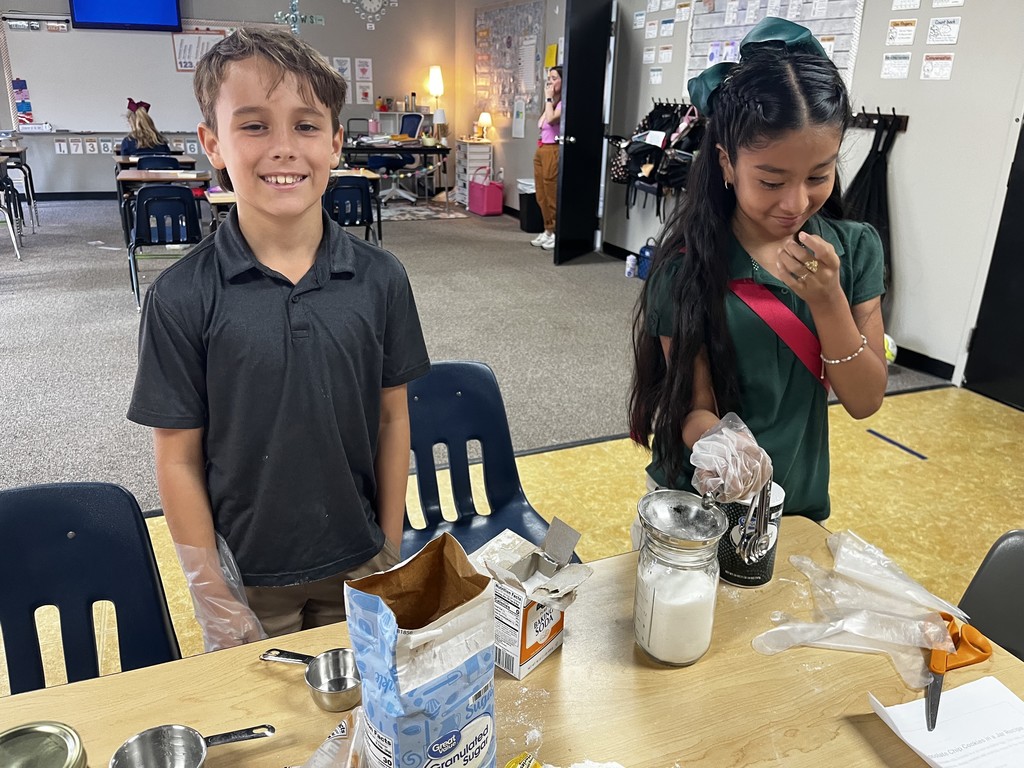 4th graders measuring ingredients for their cookie mix