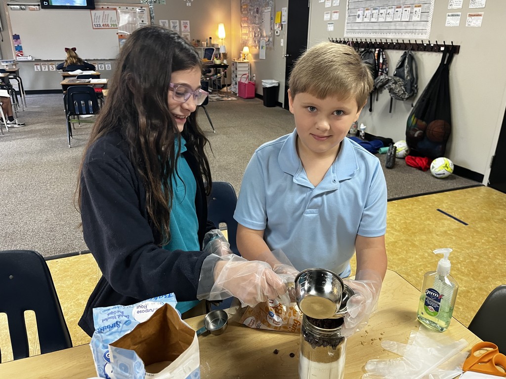 4th graders measuring ingredients for their cookie mix