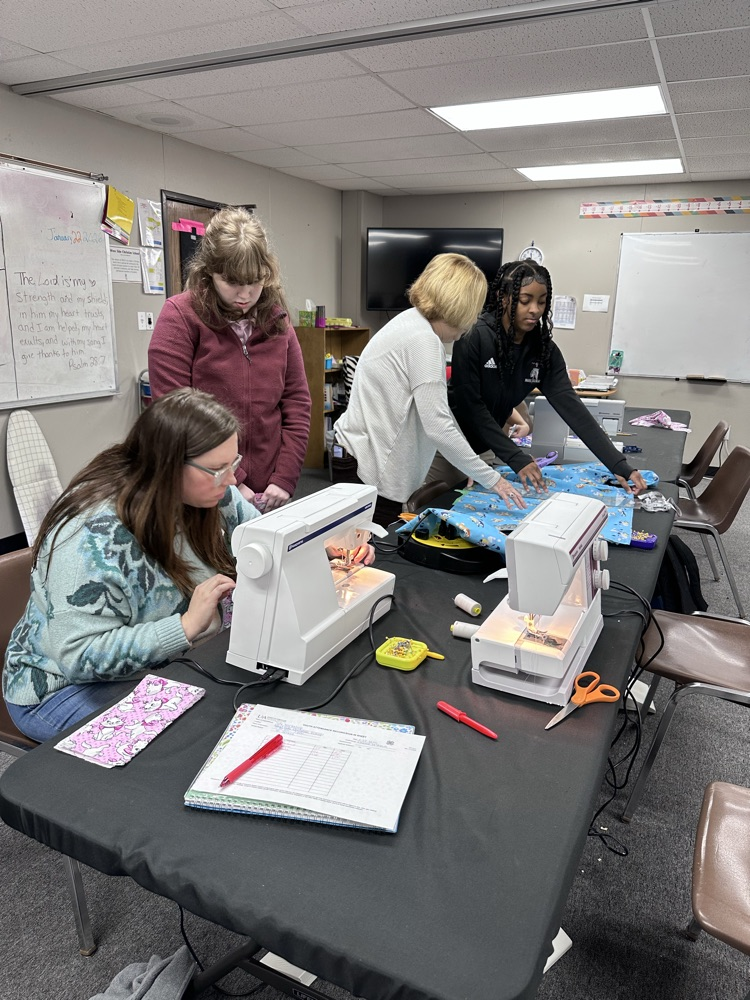 Geometry girls learning how to sew 