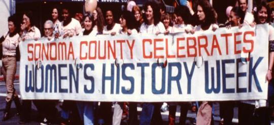 Picture of a group of women holding a banner that reads "Sonoma County Celebrates Women's History Week"