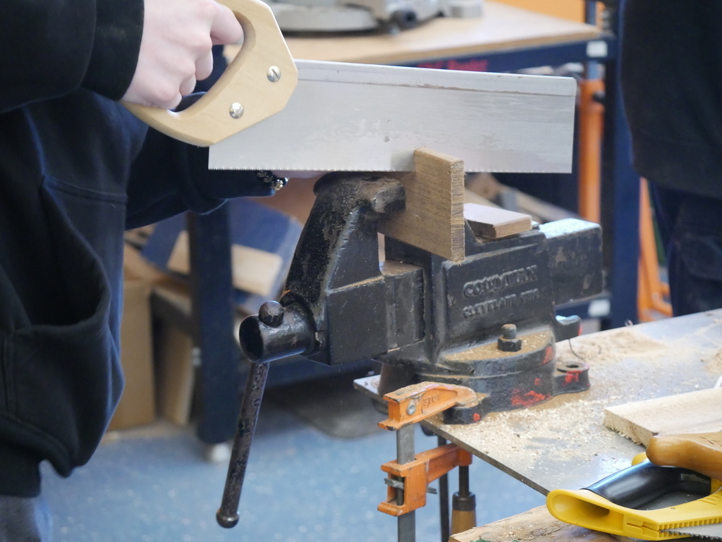 Student sawing wood