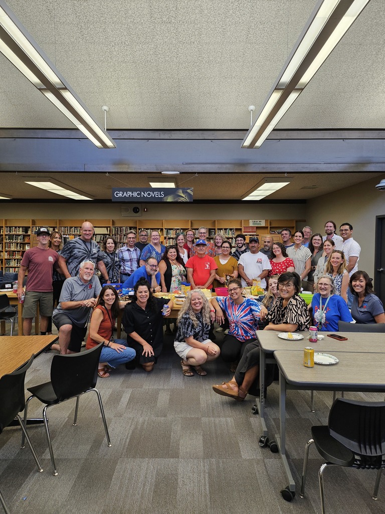 Staff posing for a picture in the library