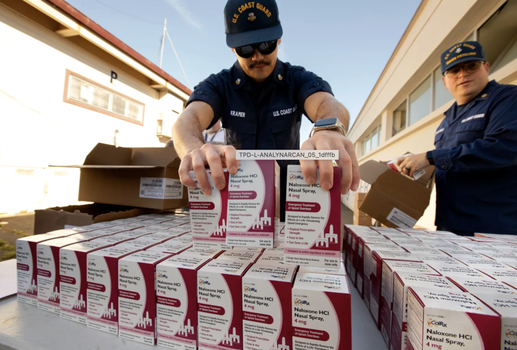 US Coast Guard member setting out boxes of Naloxone for distribution