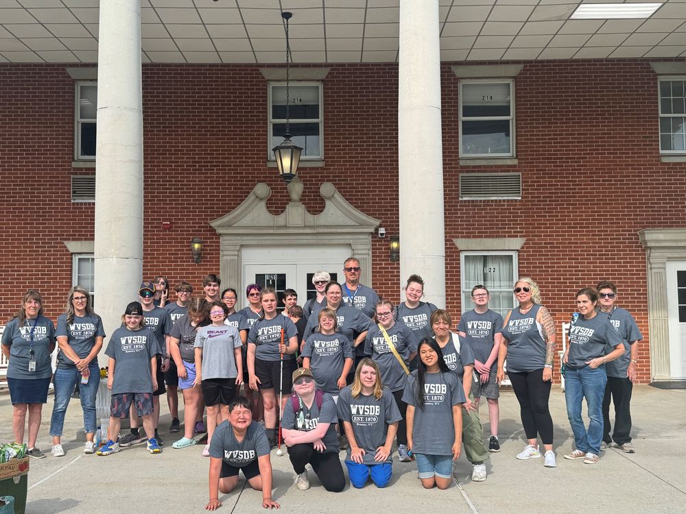 A group photo of camp participants in front of the Keller Hall Residential Hall. 